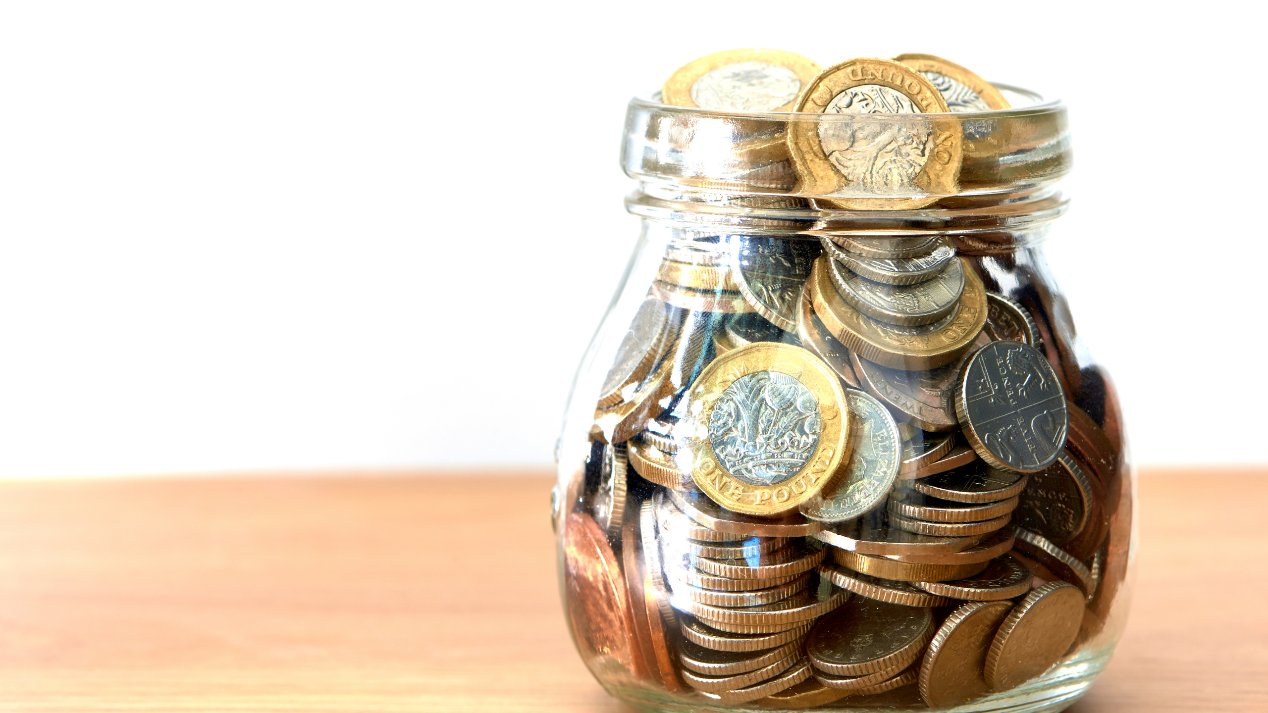 stacked round gold-colored coins on white surface
